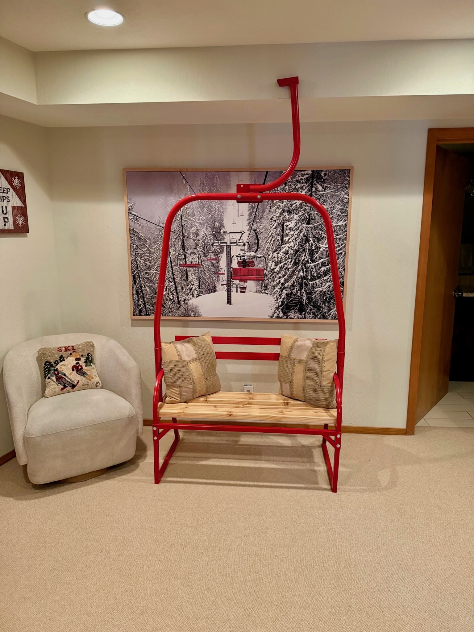 Red chairlift bench accent in the lower level