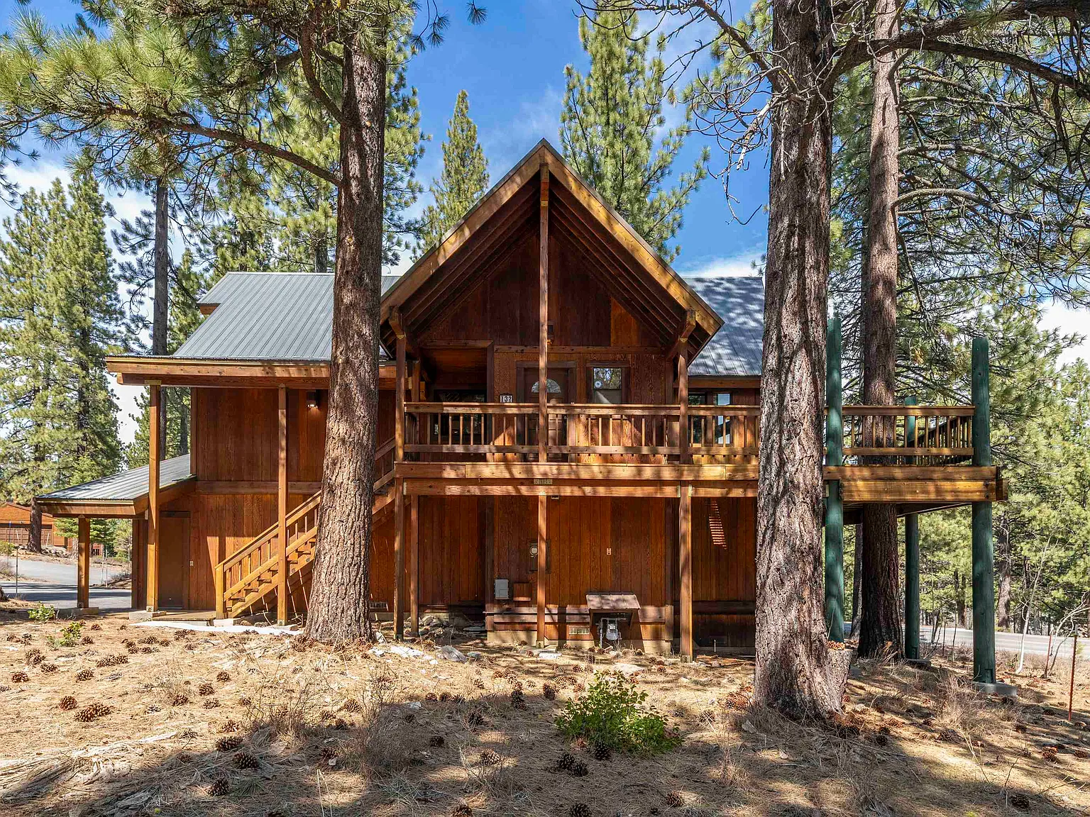 Ski & Tee Chalet exterior entrance framed by Northstar pines